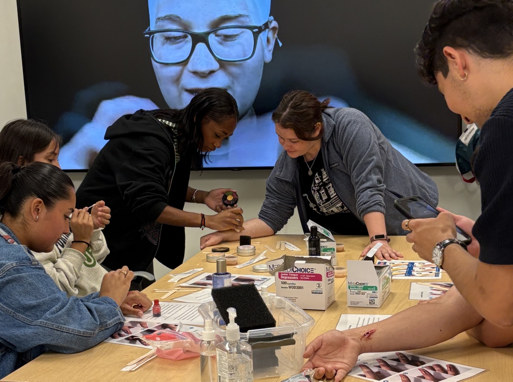 Estudiantes del programa Tilikum Summer Health Experience crean lesiones simuladas para practicar el vendaje de heridas. El programa nuevo, a través del Northwest Native American Center of Excellence de OHSU, esta diseñado para estudiantes universitarios nativos americanos y de Alaska de primer y segundo años interesados/as en carreras en el área de la salud. (Cortesía)