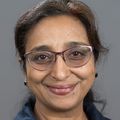 Sumathi Devarajan M.D. has long black hair, pulled back into a low ponytail, eye glasses, and a blue top.