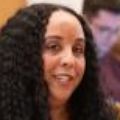 Laura Suarez, LCSW, LICSW, CADCII, at meeting. She has long curly dark hair, and wearing dark clothing.