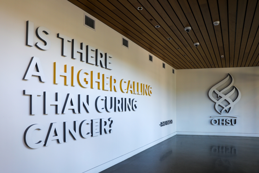 The first floor wall of the Knight Cancer Research Building features a large quote from Nike founder Phil Knight. "Is there a higher calling than curing cancer?"