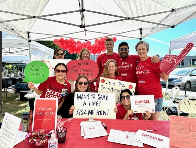 Image is of a group of nurses wearing red T-shirts and holding signs in support of bone marrow donations. The OHSU staff in the adult bone marrow transplant unit share their enthusiasm in growing the national bone marrow registry. (Courtesy)