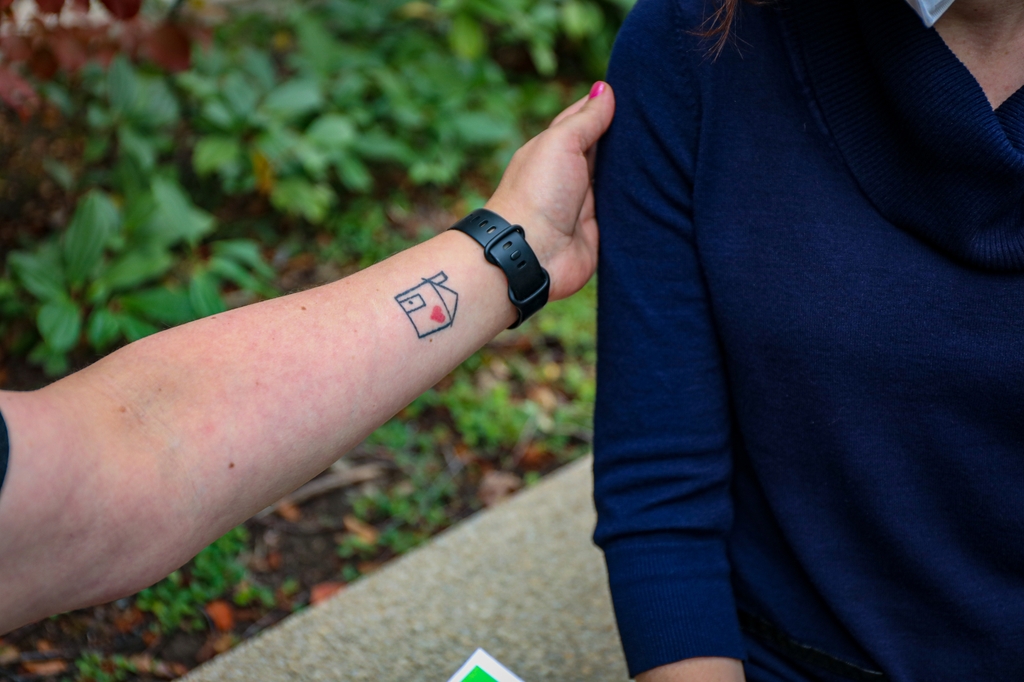 Image is of a woman touching another woman's arm in comfort. Deborah Cohen, Ph.D., is lead author of a new study that highlights how a team-based, whole-person approach to caring for pregnant people with substance use disorders can improve health outcomes and support family unity. (OHSU/Christine Torres Hicks)