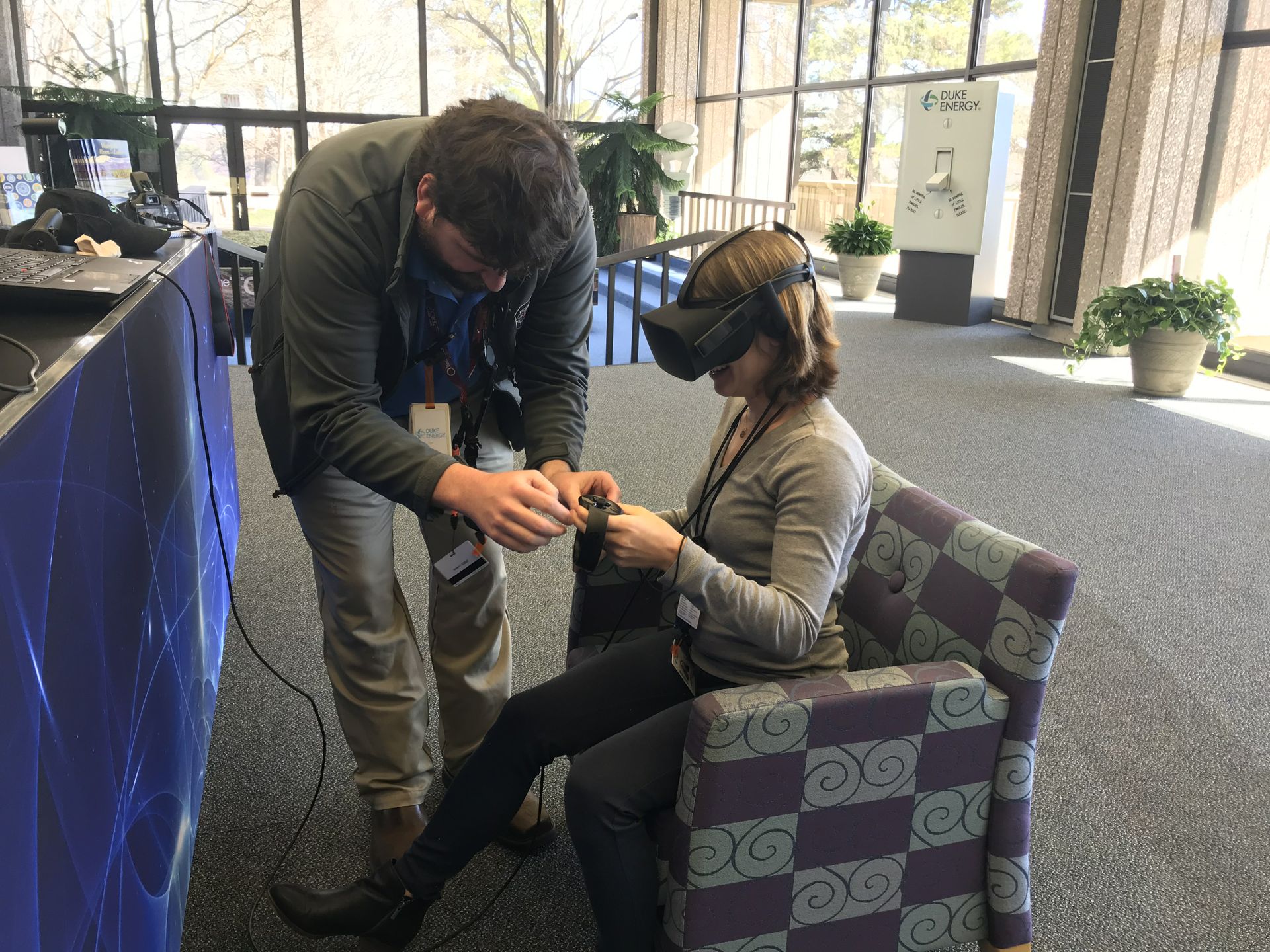 Mikayla Kreuzberger (right) using a virtual reality headset with guidance from Brad Medlin (left) at Oconee Nuclear Station's World of Energy