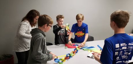 “CodeTrek Boom Squad” and “Here Comes the Boom” with YouthLink’s FIRST LEGO League make linked paper chains for their LEGO tree at the World of Energy. WOE1