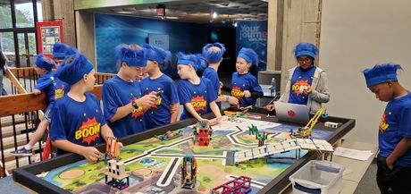 YouthLink FIRST LEGO League robotics teams demonstrate a table-tops scenario in the “Coopertition Scrimmage” at the World of Energy, where students competed against each other in advance of state qualifiers. WOE5