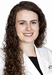 Dr. Lybbert is wearing a white lab coat and smiling into the camera