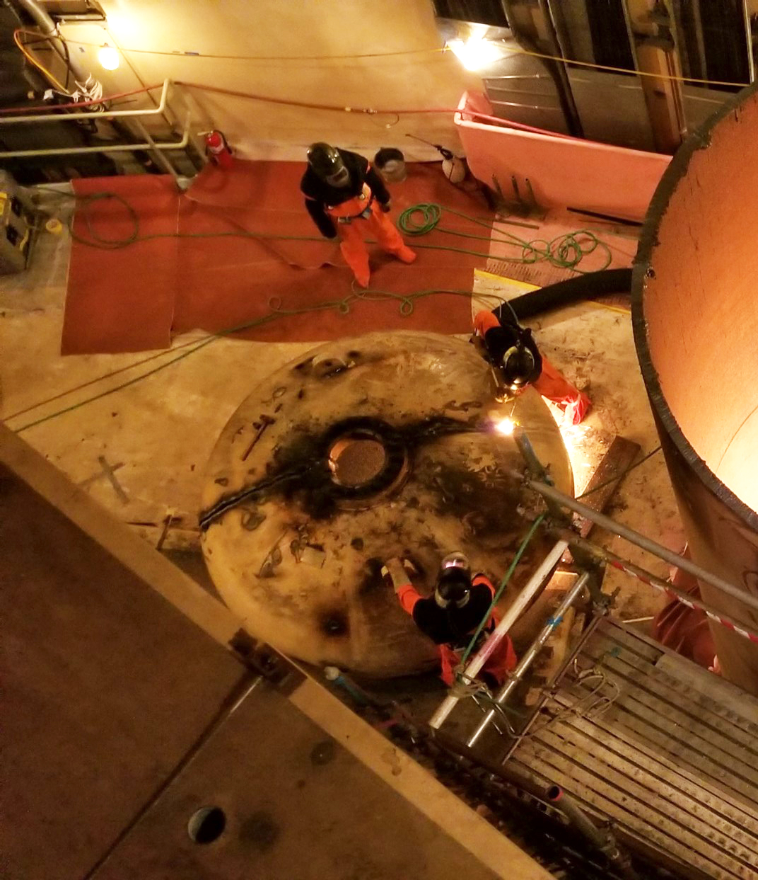 The designated "fire watch" (seen in the upper portion of the photo) keeps an eye on "hot work" taking place in the Unit 3 containment dome. Fire Watch in Unit 3