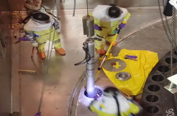An Excore Detector in Unit 2 is lifted from its housing. Excore Detector 2