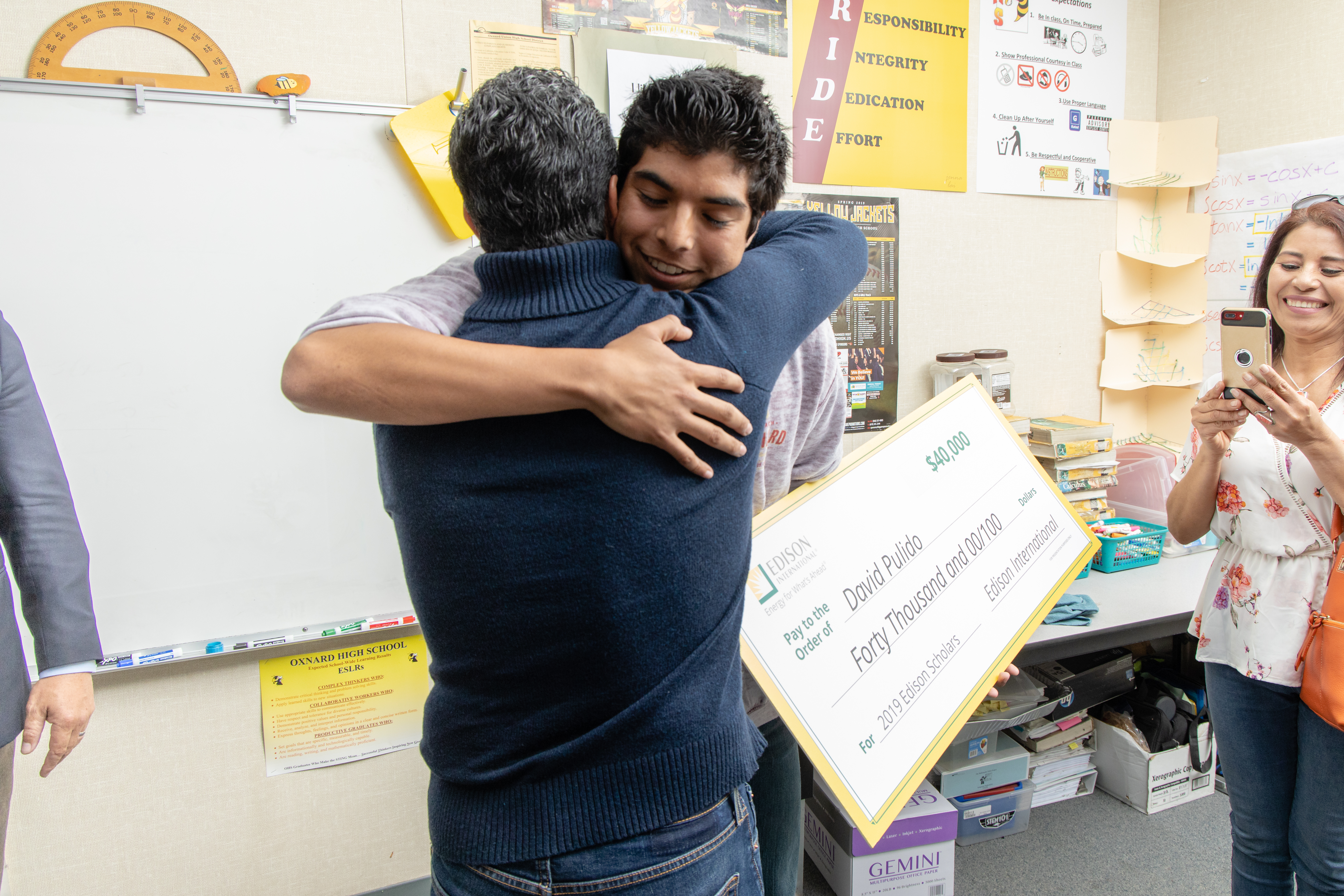 2019 Edison Scholar David Pulido hugs his dad after learning he's a 2019 Edison Scholar.