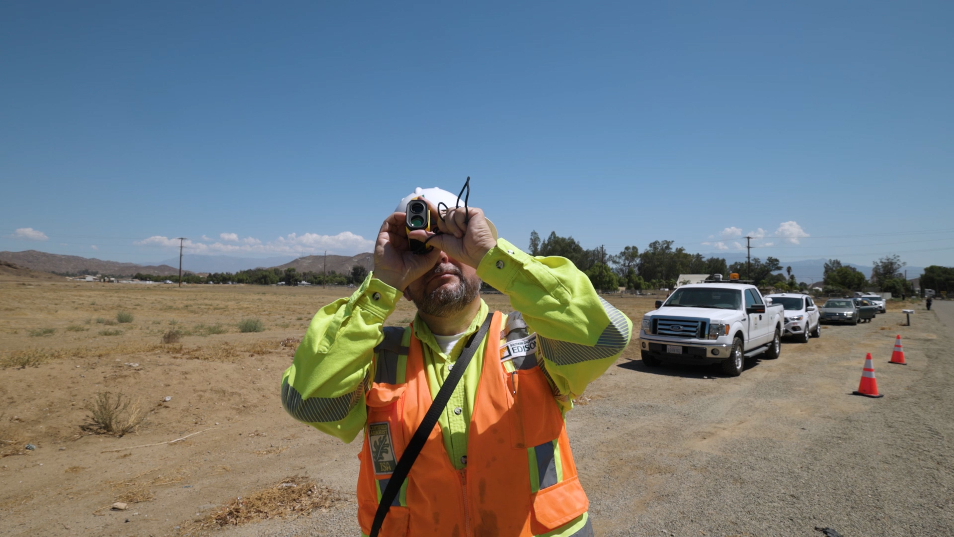 David Gonzalez, an SCE Vegetation and Forestry manager, inspects trees near power lines in Menifee.