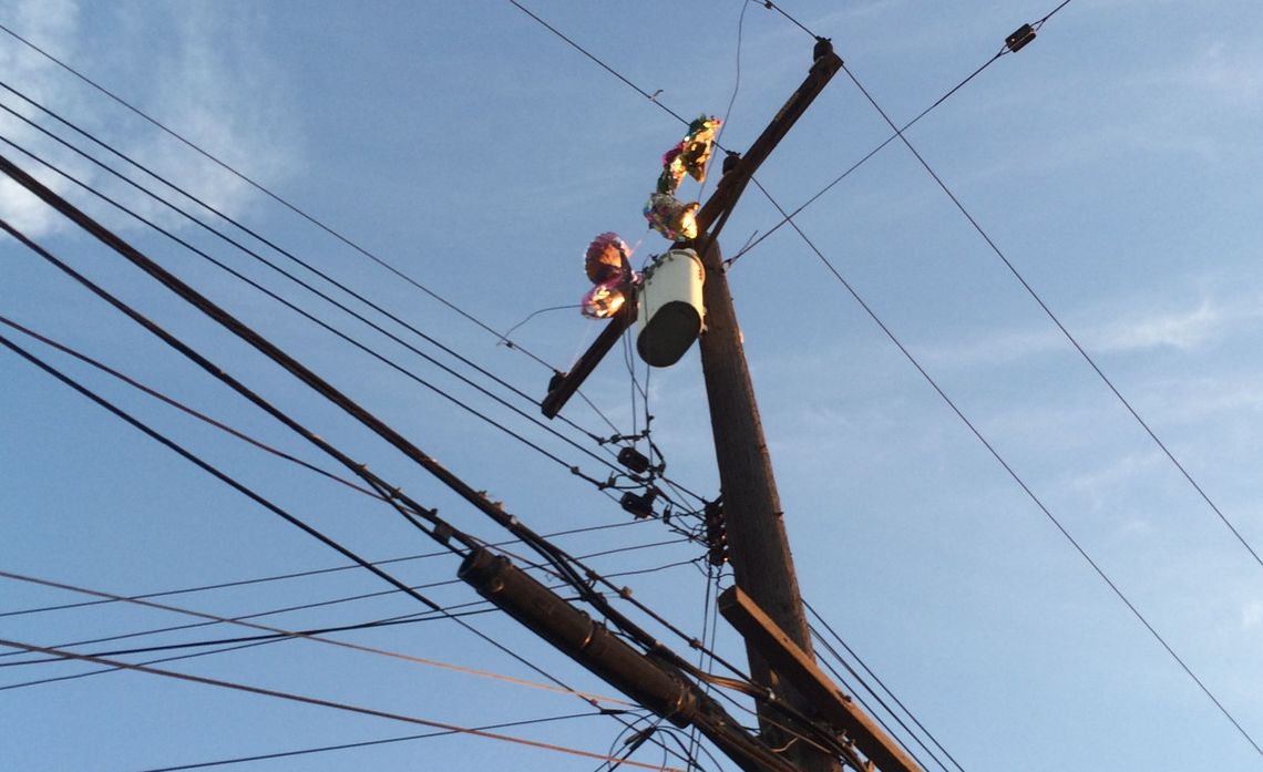 A photo of metallic balloons in power lines.