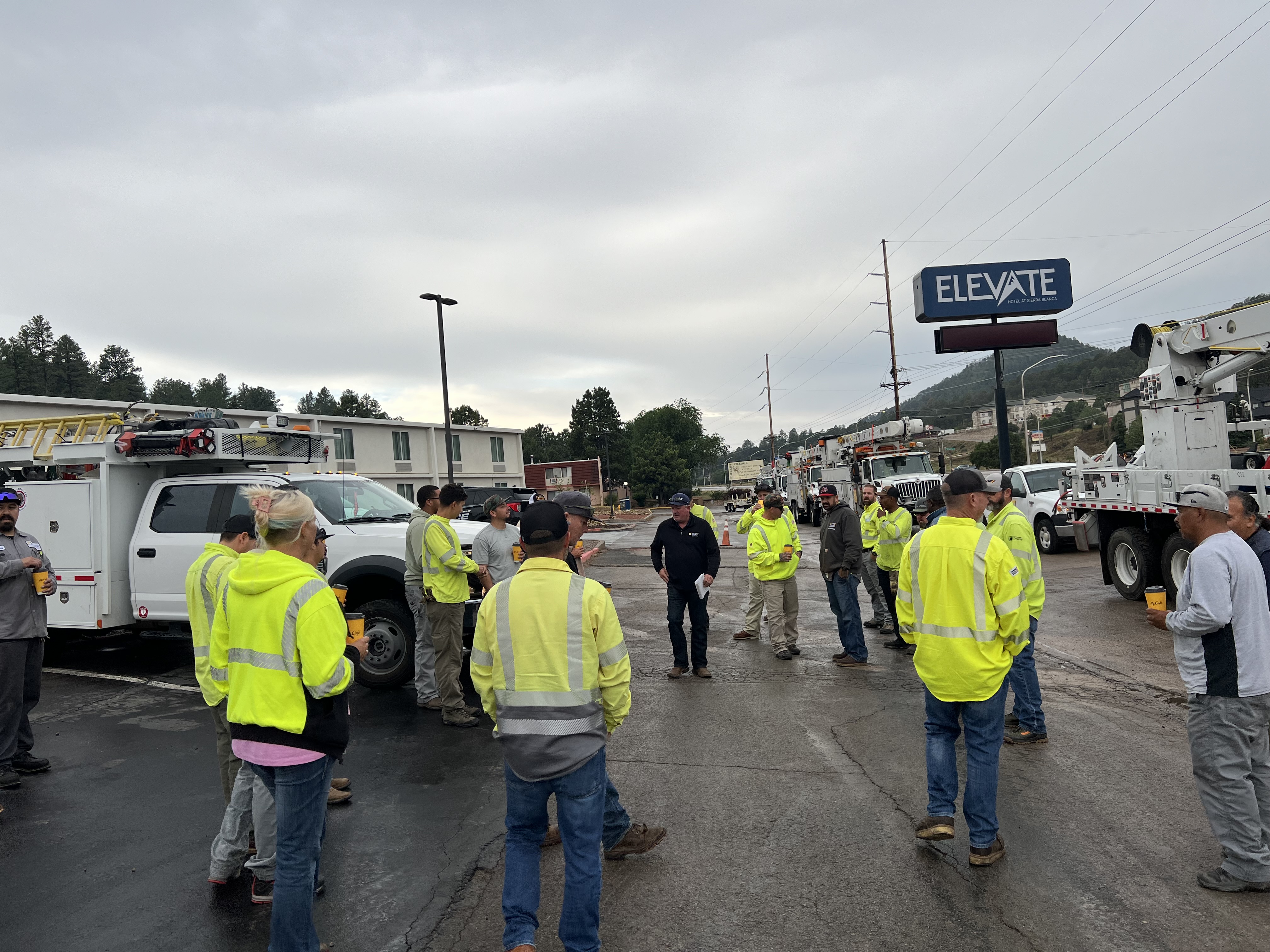 The crews huddle for the morning tailboard for their first 16-hour day to help tackle the damage in New Mexico.