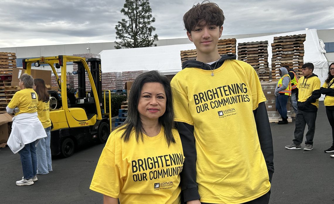 Working together, Anita Loyola Renfeldt and her son Noah demonstrate a commitment to service by helping fight food insecurity this holiday season.