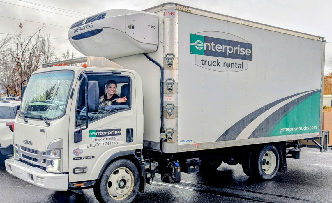 Amanda Philips steers a truck packed with groceries, traveling on snow-covered roads as part of a 1,000-mile delivery effort by Community Service Solutions.