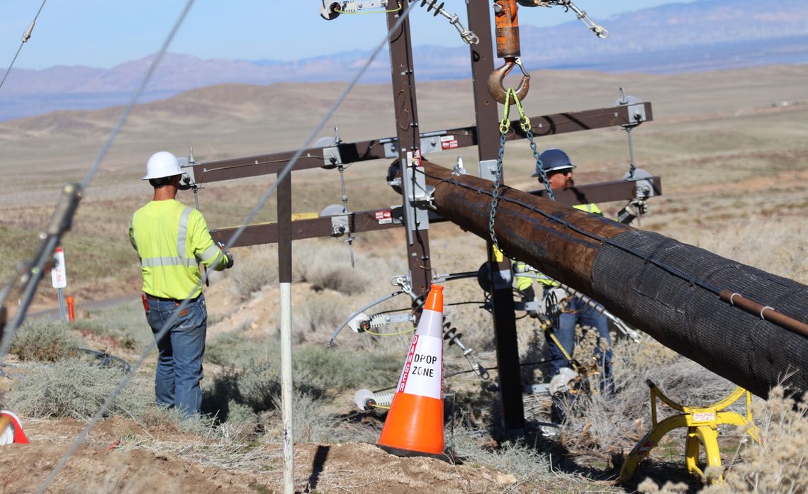Upgrading poles from wood to fiberglass helps reduce wildfire risk in the Lake Hughes community.