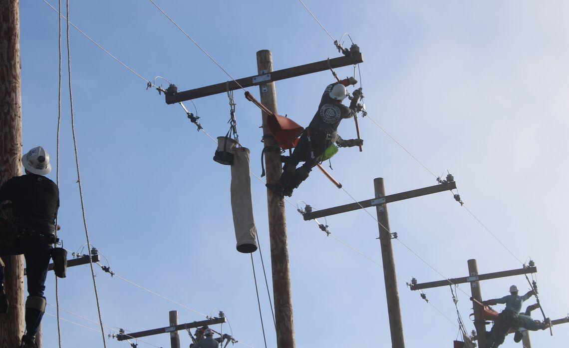 Journeyman teams complete a Dead-End Insulator Change Out, one of several events featured at the International Lineman's Rodeo.