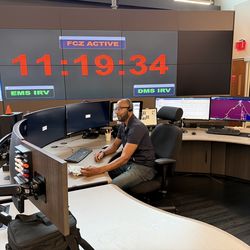 At his console, Charles Bennett tracks shifting grid conditions to direct electricity along safer, steadier routes.