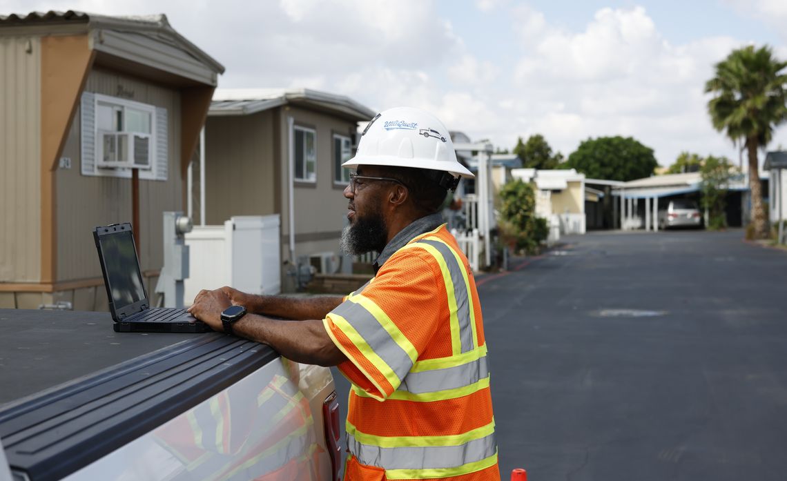 Reviewing maps and 811 requests on his laptop, Darris McCoy, assistant manager of Operations Management at UtiliQuest prepares to locate underground utility lines at a mobile home park in San Bernardino.