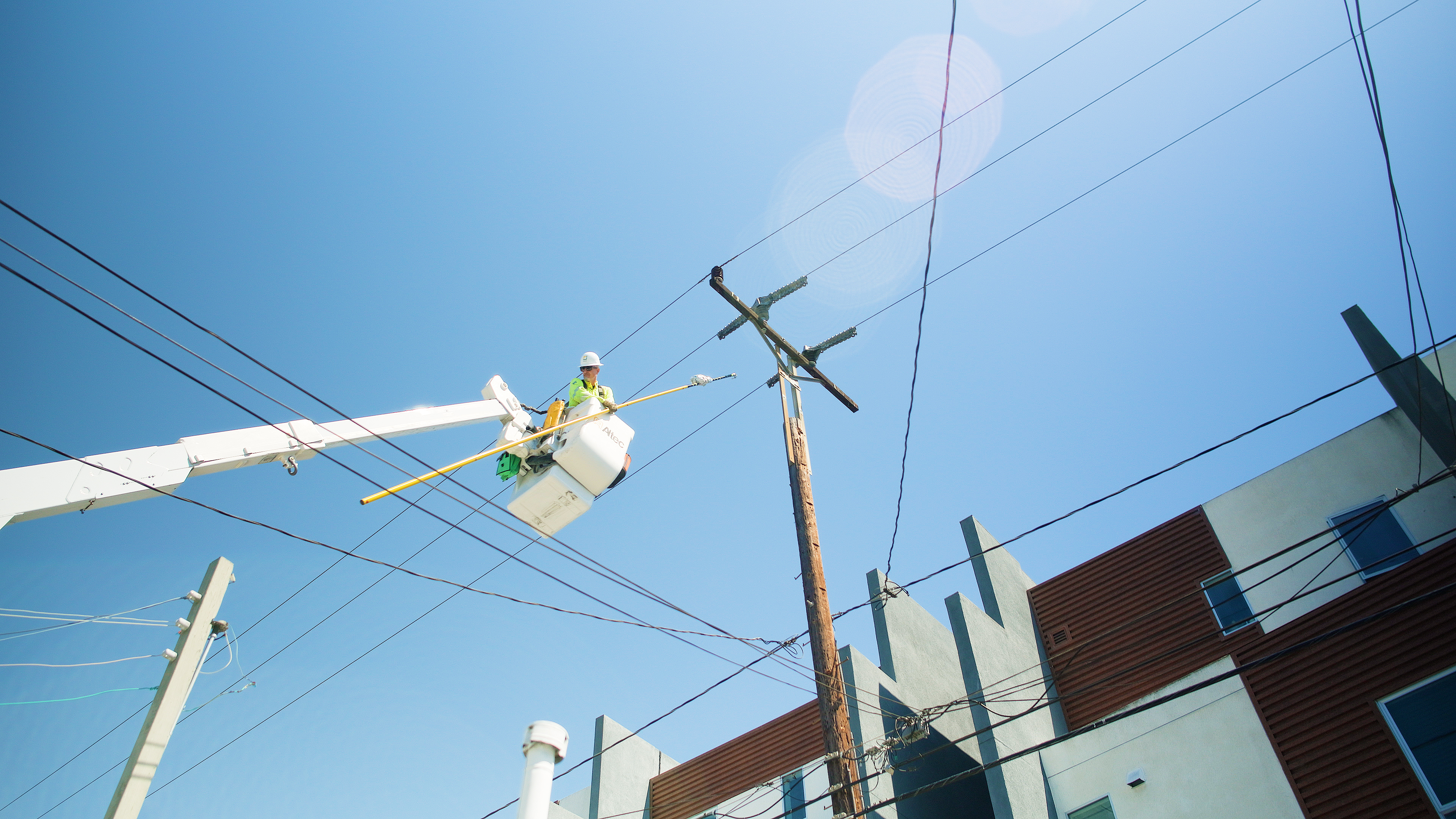 Matt McLain removes mylar balloons from power lines. 