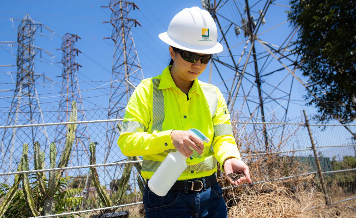 Colby Rochelle Wong sprays a handful of soil with water to better understand the soil’s texture and plasticity. 