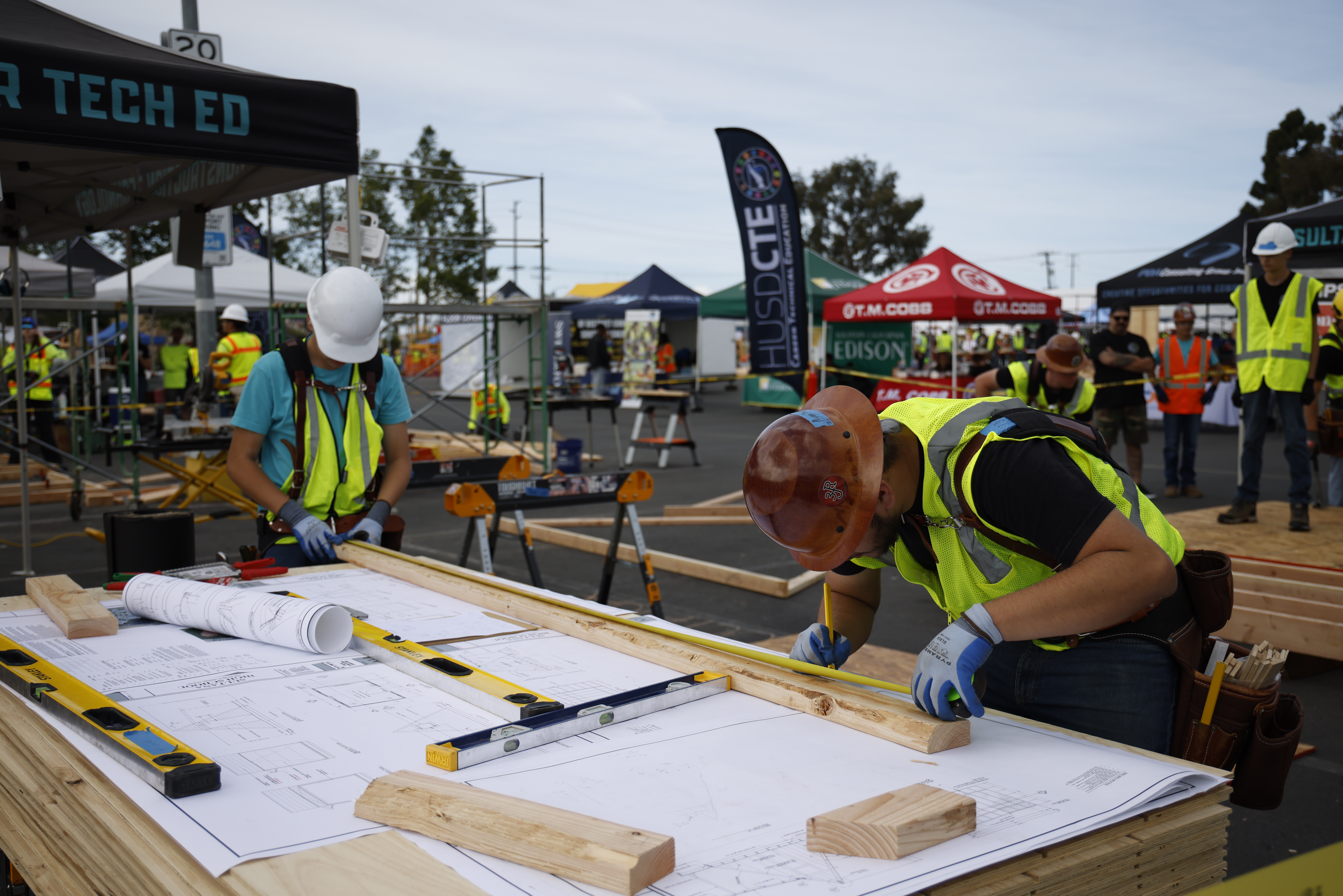 Students measure, cut and assemble materials as their designs come to life on the competition floor.