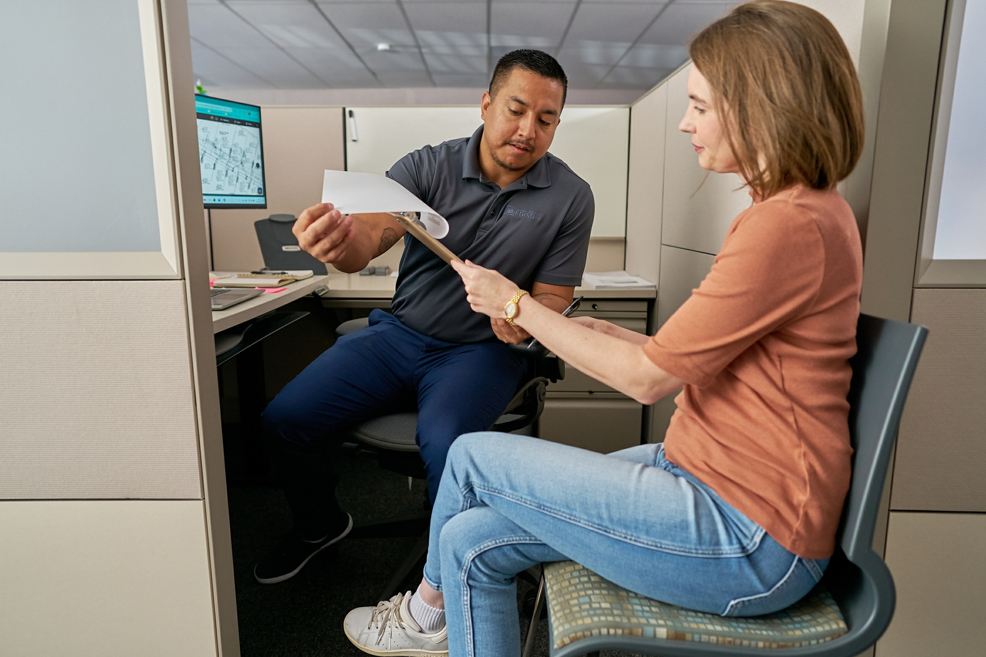 SCE Customer Service Representative Daniel Cortez (left) works directly with customers who are rebuilding and recovering after the Eaton Fire.