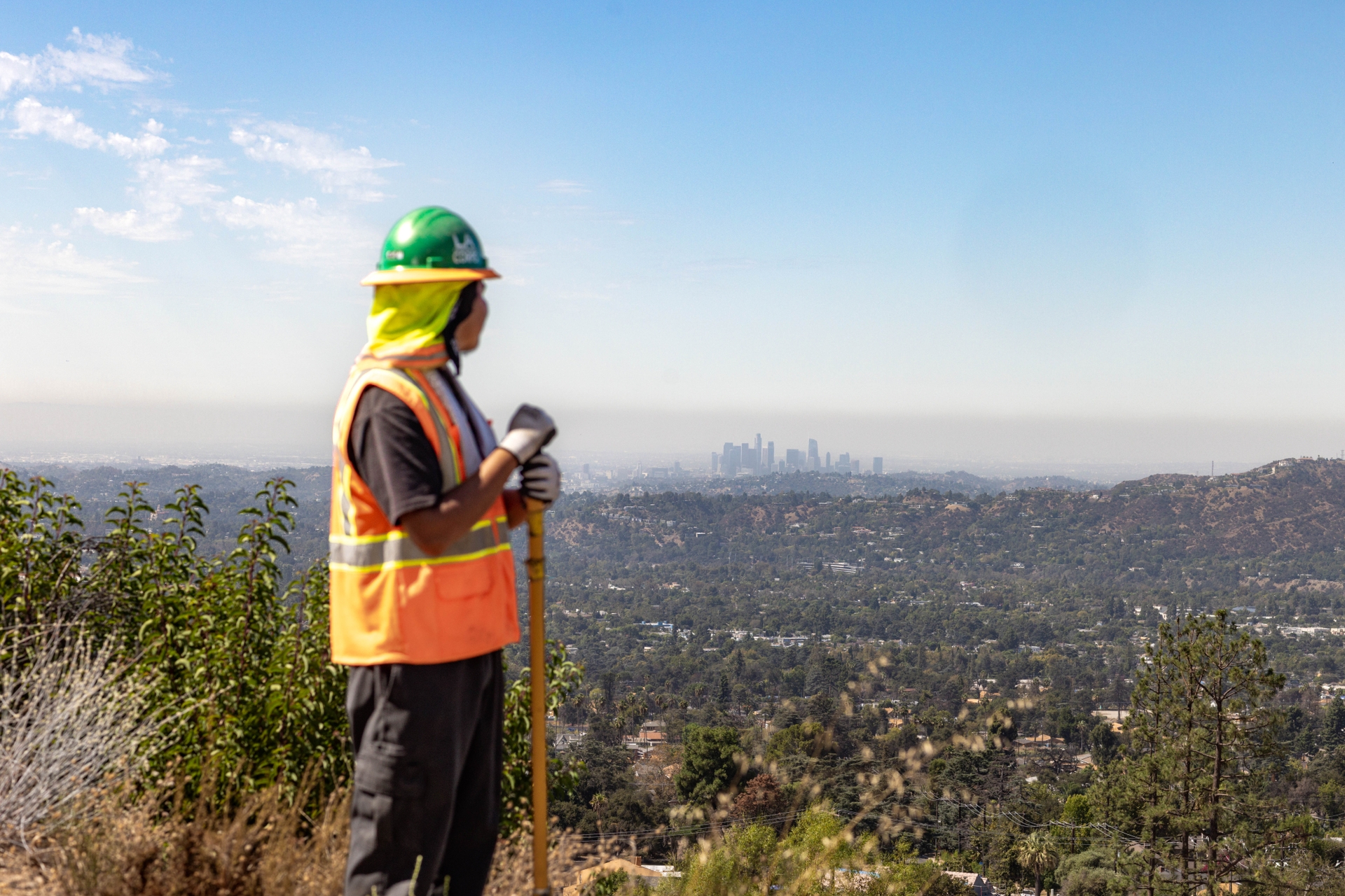 LA Conservation Corps crew member Julio Olivares helps clear and restore trails in Altadena that were damaged by the 2025 Eaton Fire.