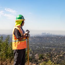 LA Conservation Corps crew member Julio Olivares helps clear and restore trails in Altadena that were damaged by the 2025 Eaton Fire.
