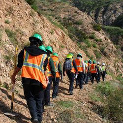 Members of the LA Conservation Corps hike into the Altadena Crest Trail to support wildfire recovery efforts.