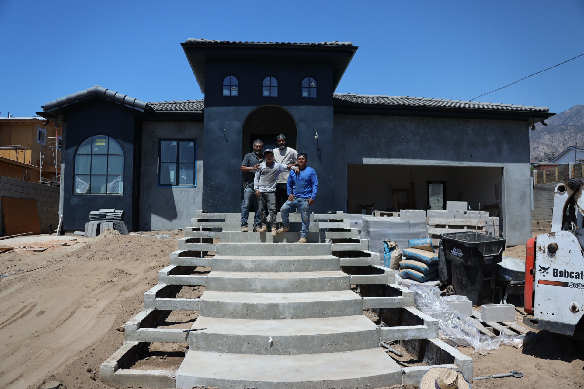 Jason Guyton (back right) is partnering with contractors to rebuild his home in Altadena, where he plans to live with his family for the foreseeable future.