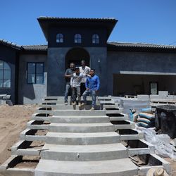 Jason Guyton (back right) is partnering with contractors to rebuild his home in Altadena, where he plans to live with his family for the foreseeable future.