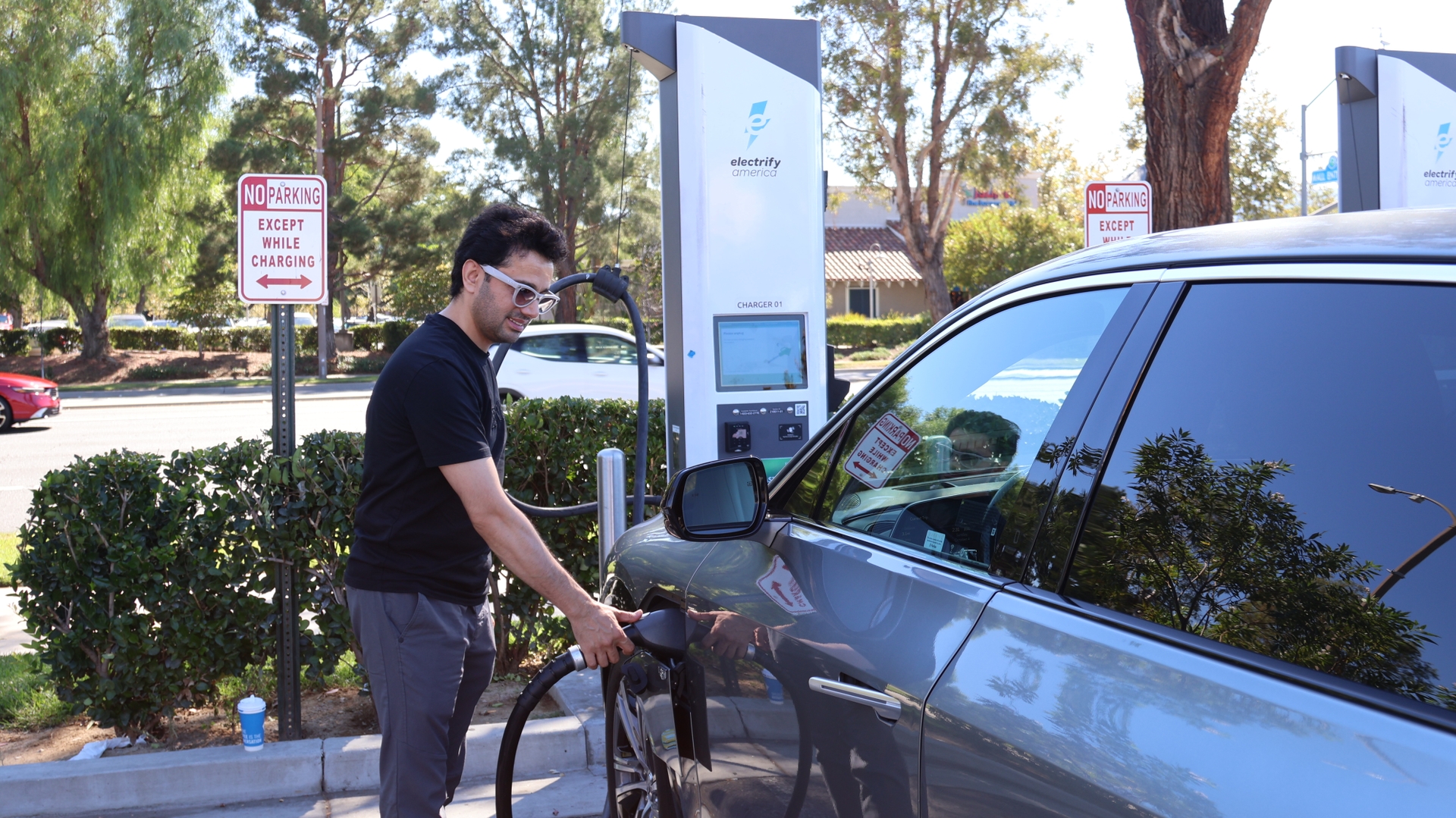 Plugging in near his Valencia home, Naim Rahim charges the EV that an SCE rebate helped him afford.