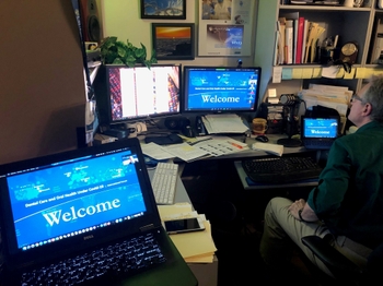 Keith in front of four monitors