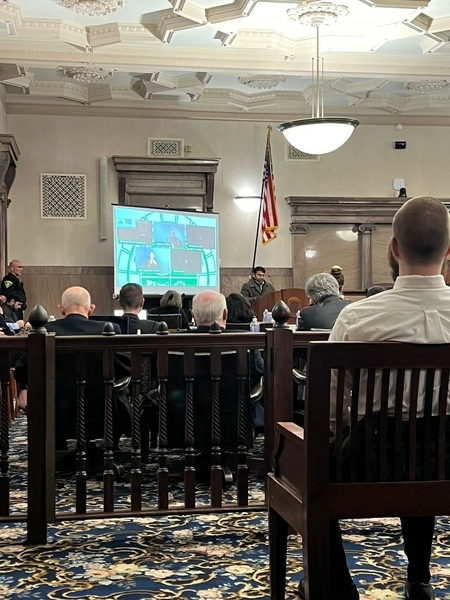 Dr. Chakraborty at podium in large room.