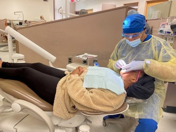 Dr. Almirza treating patient in dental chair 