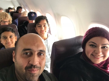 A selfie of the family of four on an airplane