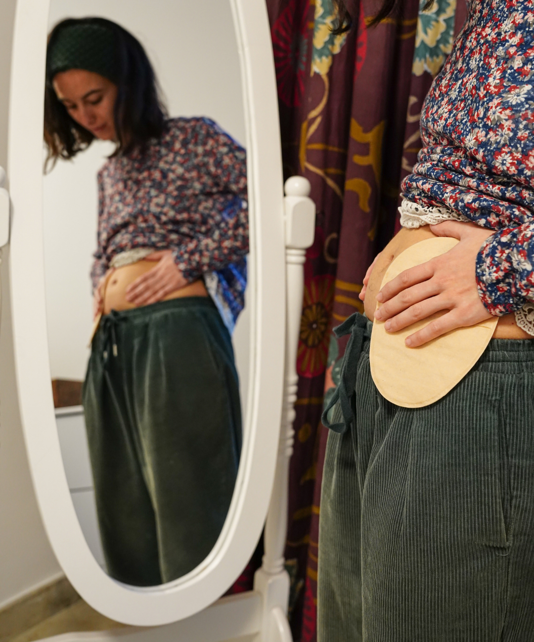 Person with ostomy bag looking in the mirror