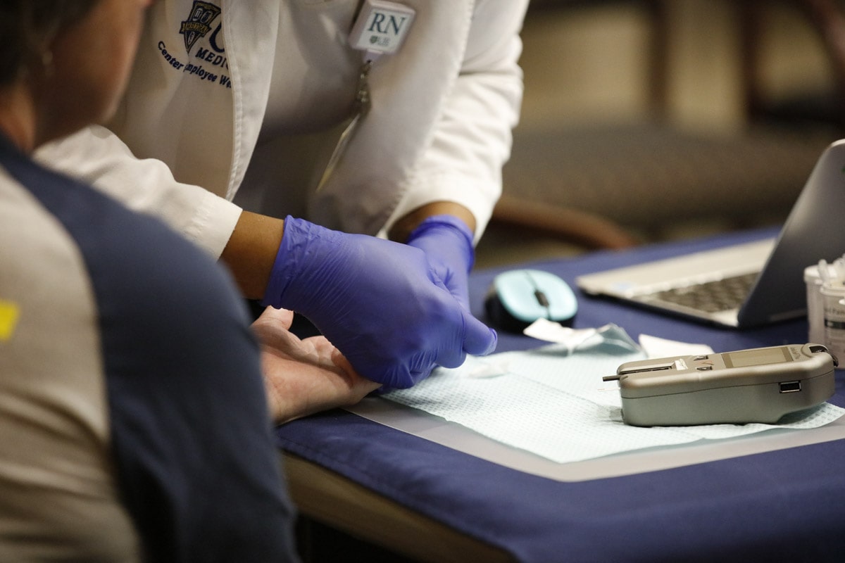Registered nurse conducting a biometric screening.