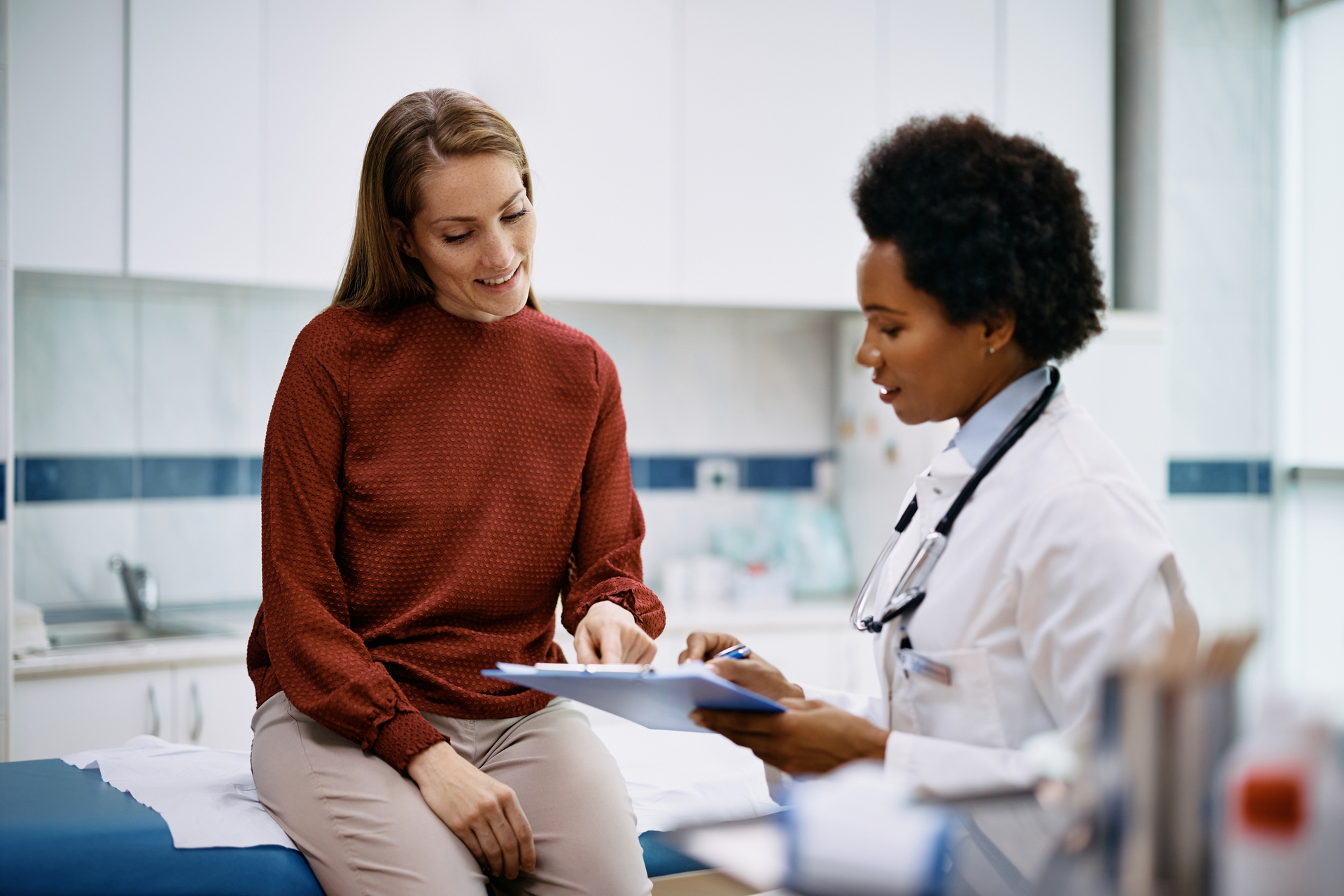 A woman speaks with her health provider in a doctor's office
