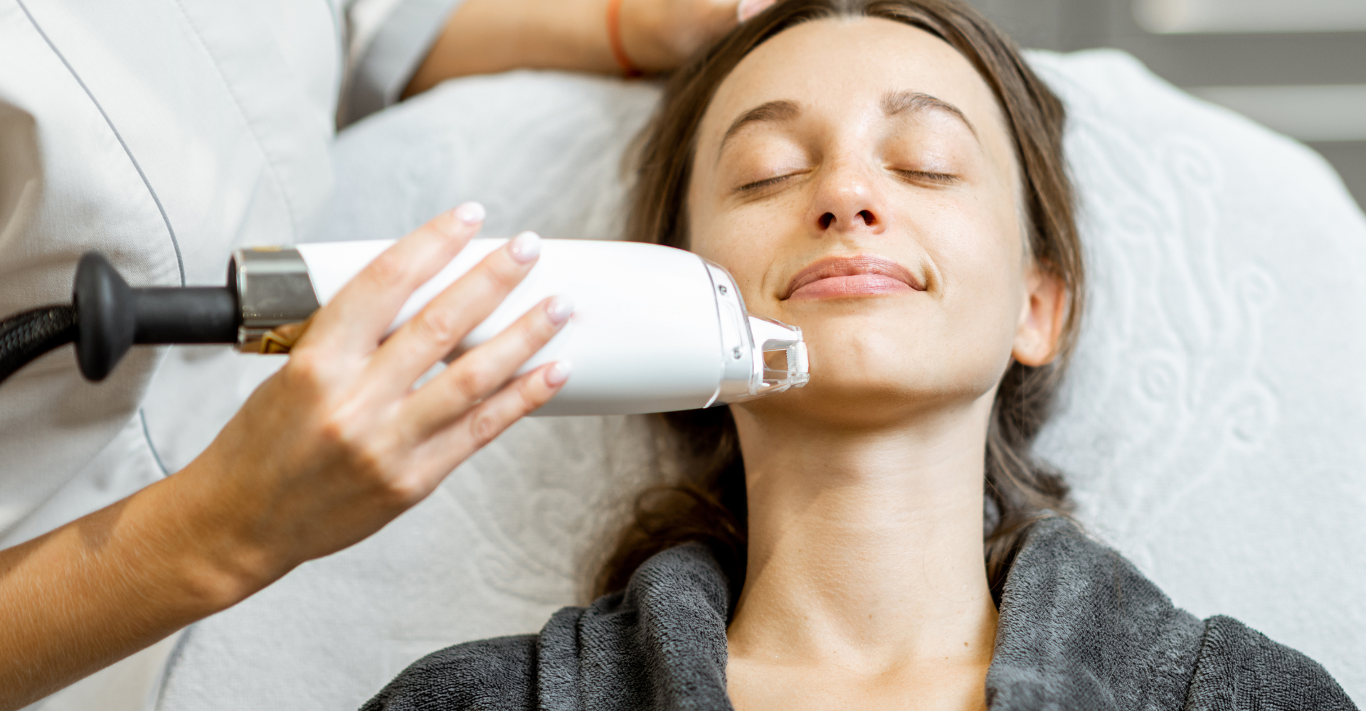 Woman lays head back while dermatologist uses clear + brilliant laser treatment on her chin.