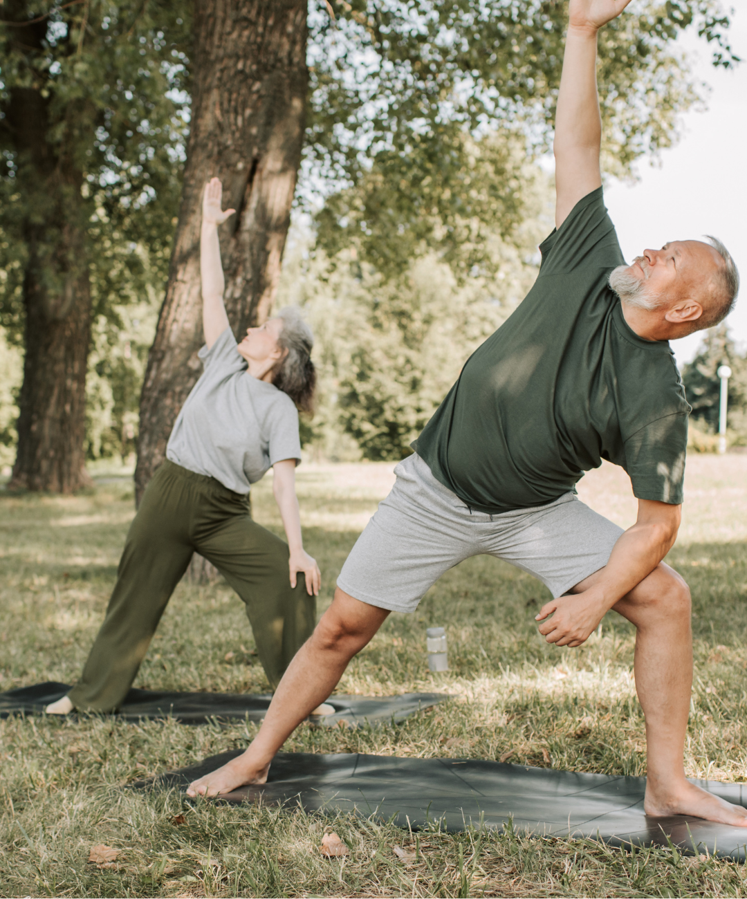 Two people doing yoga outside