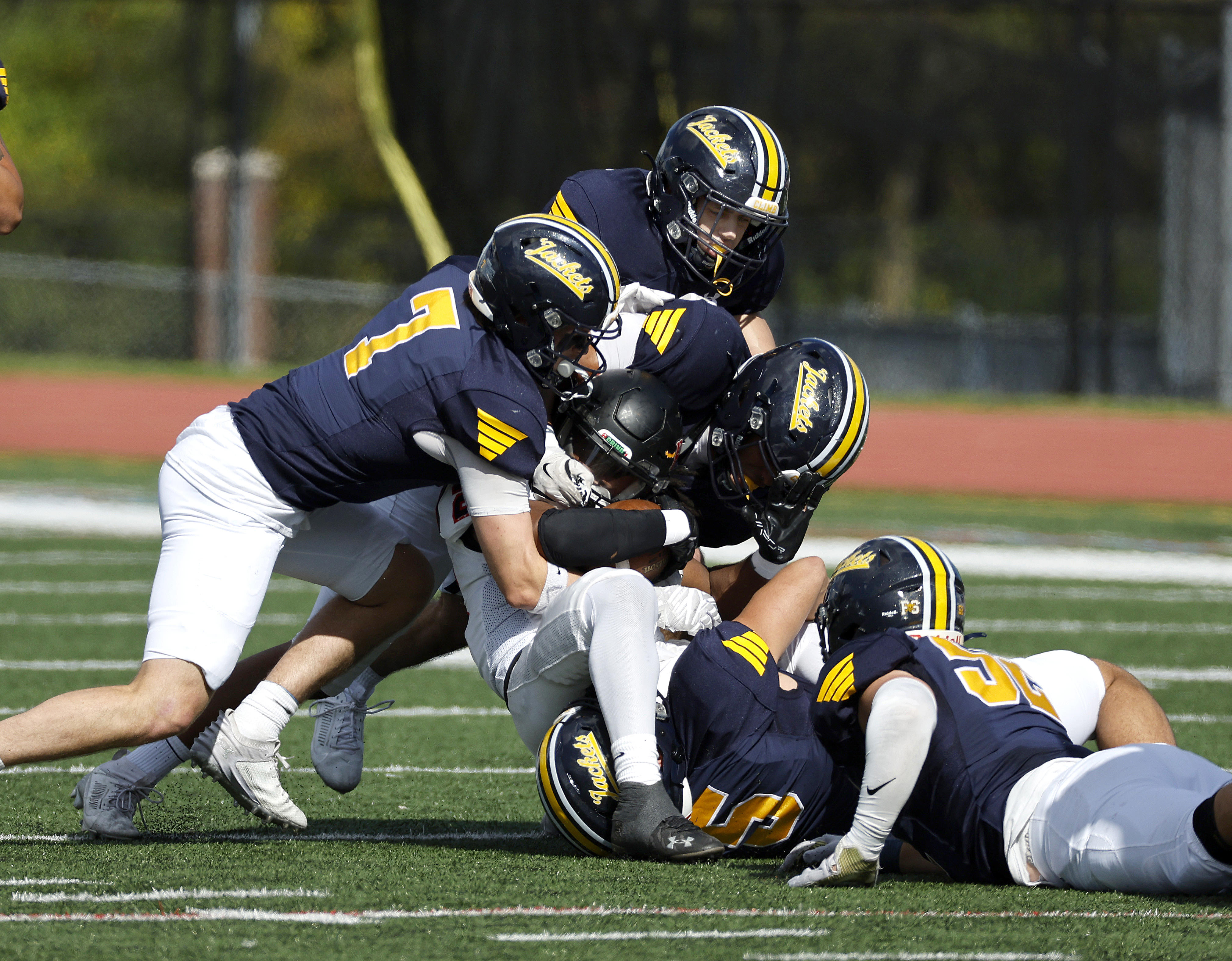 University of Rochester Football players making a contact play in game.