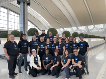 group of dentists in matching shirts at airport