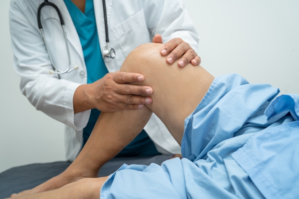 doctor examining leg