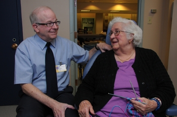 Lin Saunders and patient looking at each other. Patient is sitting in dental chair.