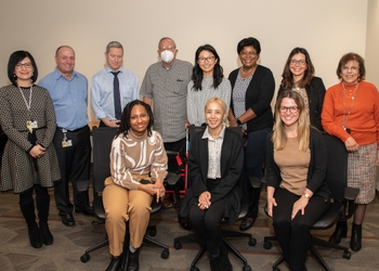 a group of people. The left side of the back row includes Drs. Linda Rasubala, Sean McLaren, Eli Eliav, and Walter Psoter.