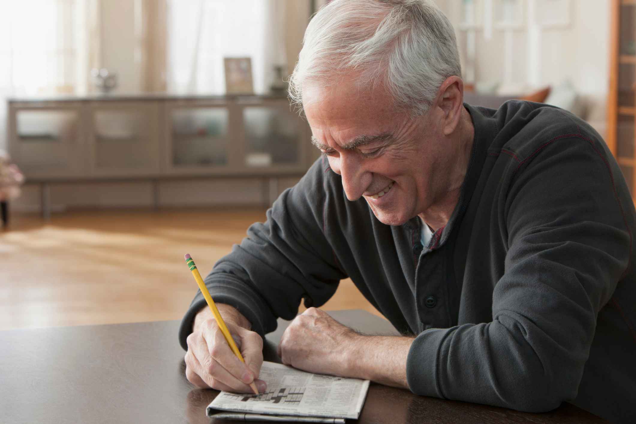 man doing a crossword puzzle