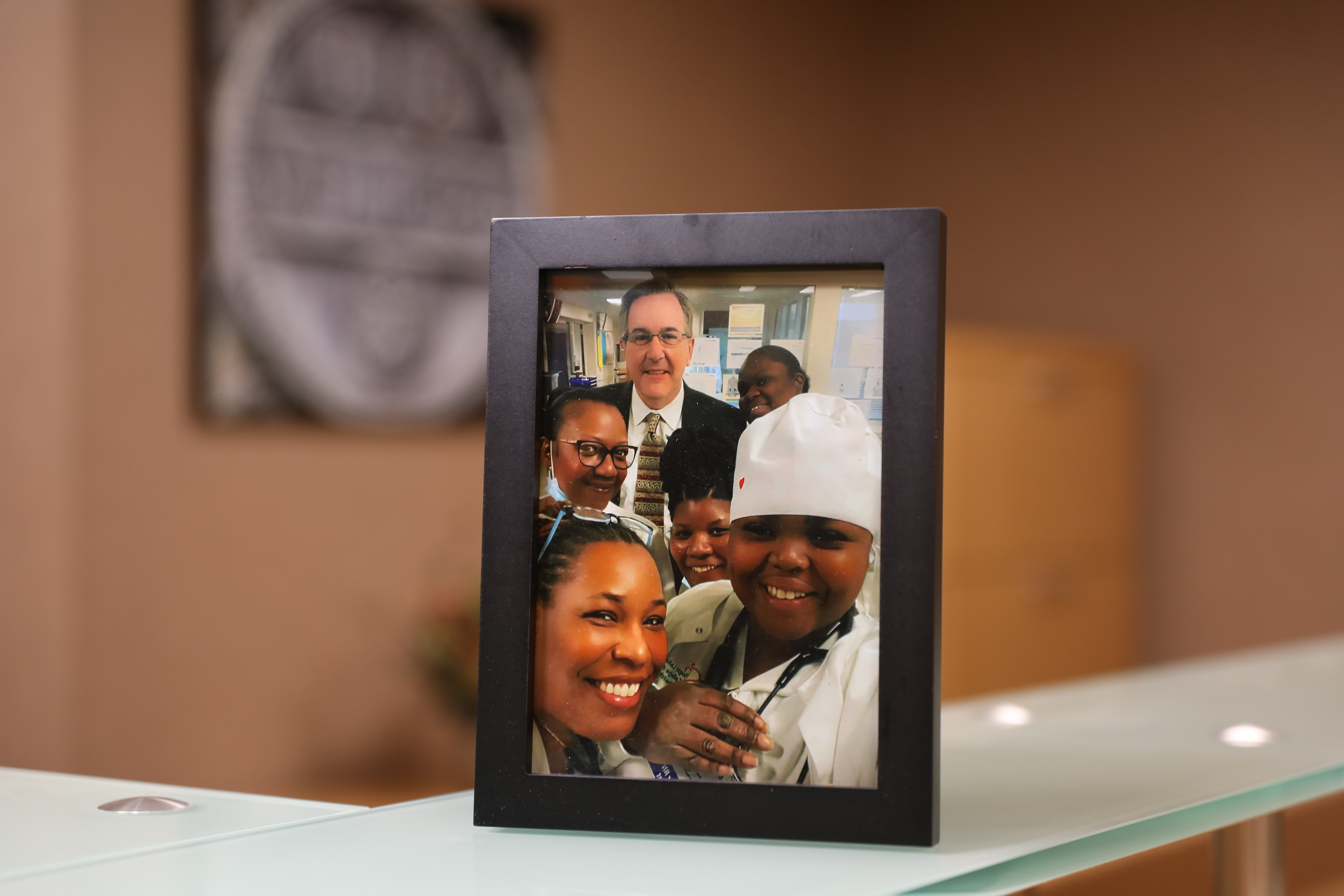 Framed picture of Dr. Linehan taking a selfie with smiling kids