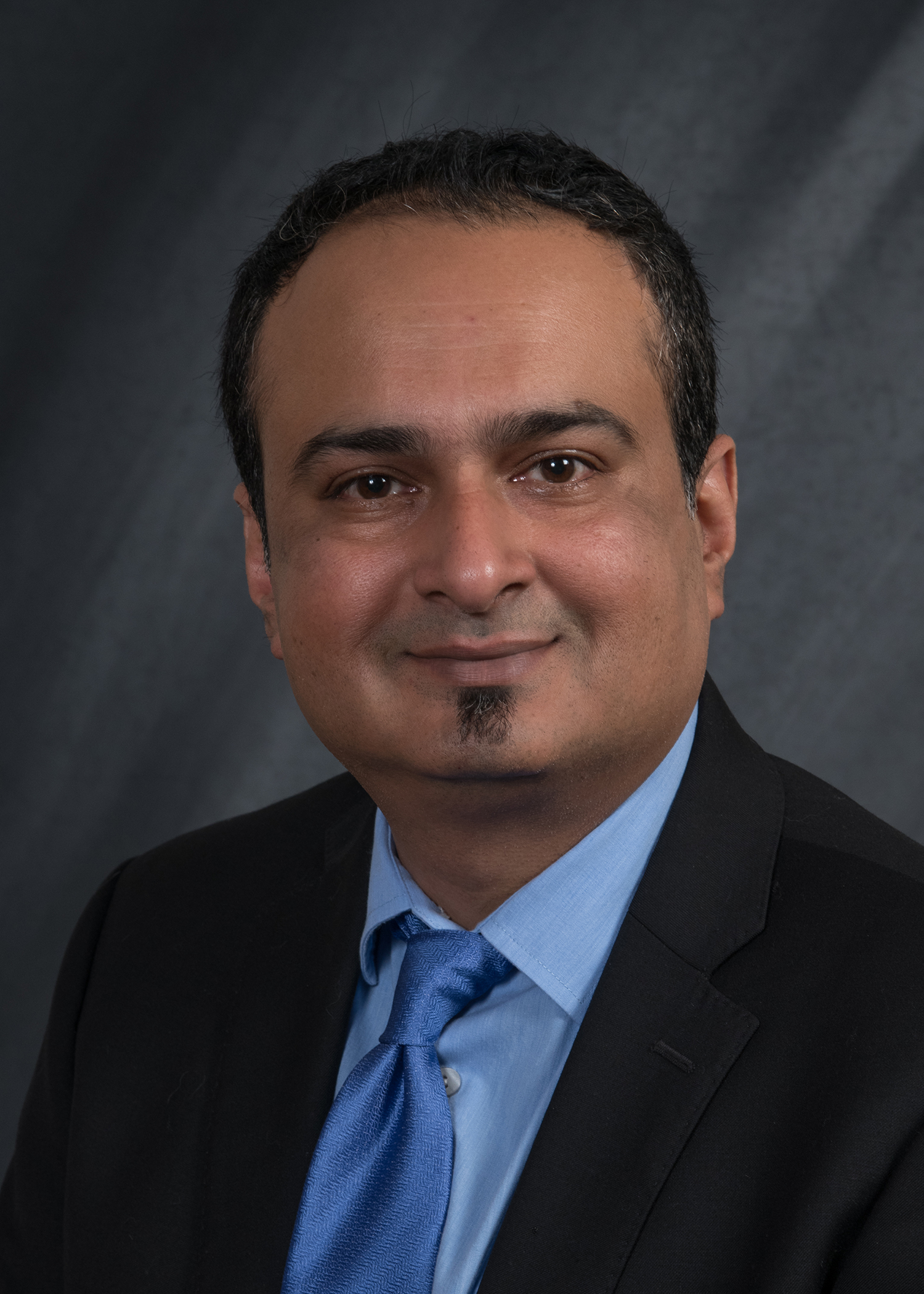 A portrait of Dr. Fawad Javed.