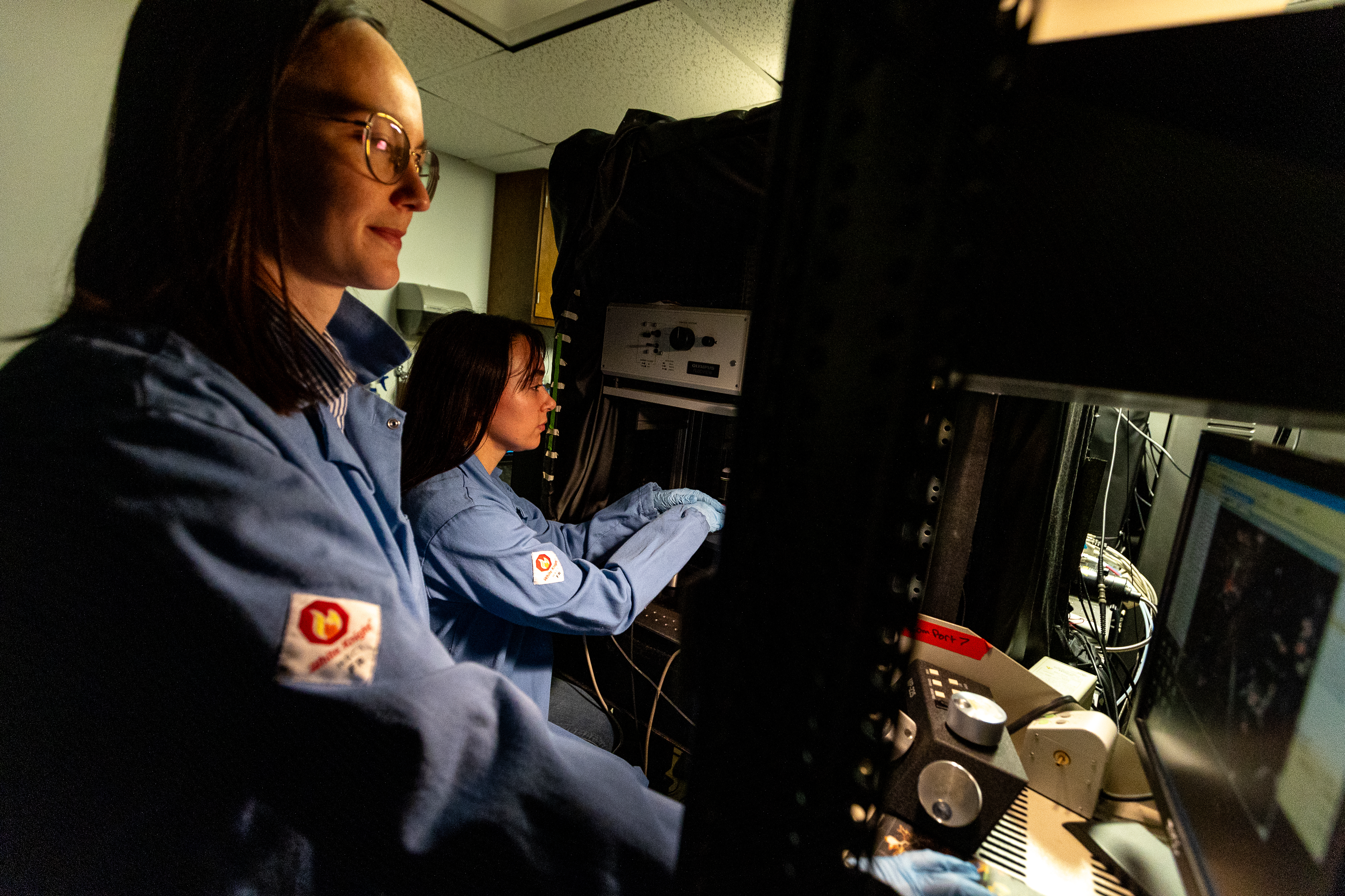 Plunk (left) and Neuroscience graduate student Alexis Feidler (right) use a confocal microscope in the Majewska Lab at the University of Rochester Intellectual and Developmental Research Center.